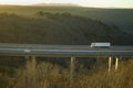 Truck on viaduct on the highway of La Plata, Salamanca dazzled by the sun