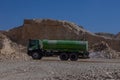 Truck with water on centre of deserted quarry