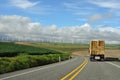 Trucking Bales of Straw by a Wind Farm Royalty Free Stock Photo