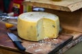 Truckle of farmhouse cheese on cut board Royalty Free Stock Photo