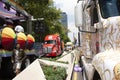 Trucks adorned with rainbow umbrellas parading alongside the contingent of the march for LGBTTTI pride