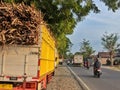 Trucks carrying Sugarcane are parked waiting their turn on the edge of the Madiun highway, East Java in the afternoon