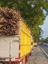 Trucks carrying Sugarcane are parked waiting their turn on the edge of the Madiun highway, East Java in the afternoon