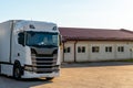 Trucks with containers in the parking lot along the highway against the background of clouds. The concept of logistics, transport Royalty Free Stock Photo