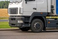 Trucks with containers in the parking lot along the highway against the background of clouds. The concept of logistics, transport Royalty Free Stock Photo