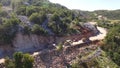 Trucks and excavators widen the road in the mountains