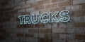 TRUCKS - Glowing Neon Sign on stonework wall - 3D rendered royalty free stock illustration