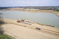 Trucks leaving an active sand pit