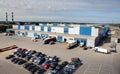 Trucks are loaded and unloaded at a large warehouse, top view of the warehouse and parking loading and unloading.