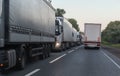 Trucks move in opposite directions on a suburban highway