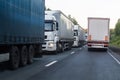 Trucks move in opposite directions on a suburban highway