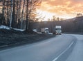 Trucks move on a suburban highway in the winter Royalty Free Stock Photo