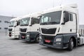 Trucks parked in a parking lot in a row. Automobile transportation. Logistics and transport, close-up