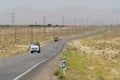 Trucks pass by the countryside road circa Yazd, Iran.