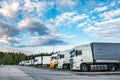 Trucks in a row with containers in the parking lot near forest , Logistic and Transport concept Royalty Free Stock Photo