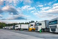 Trucks in a row with containers in the parking lot near forest , Logistic and Transport concept Royalty Free Stock Photo