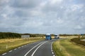 Trucks on a Rural Highway Under Cloudy Skies Royalty Free Stock Photo