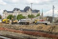 Trucks and tractors working at an under construction site