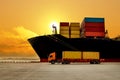 Trucks and trailers receive container at port from large ship.