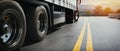 Trucks are transporting goods through a road that stretches through the mountains