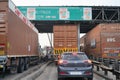 Trucks and vehicles waiting at an NHAI toll booth with FASTag cashless payment callout