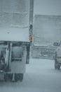 Trucks on winter highway during snowstorm