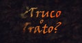 Truco o Trato (Trick or Treat) Spanish text dissolving into dust from left Royalty Free Stock Photo