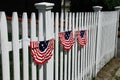 American flag banners on white picket fence Royalty Free Stock Photo