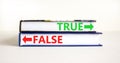 True or false symbol. Concept word True or False on beautiful books. Beautiful white table white background. Business and true or
