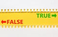 True or false symbol. Concept word True or False on beautiful yellow paper. Beautiful white paper background. Business and true or
