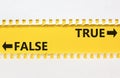 True or false symbol. Concept word True or False on beautiful yellow paper. Beautiful white paper background. Business and true or Royalty Free Stock Photo