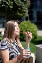 Happy beautiful caucasian woman blowing soap bubbles outdoor in a sunny day Royalty Free Stock Photo