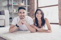 True love. Happy beautiful married latino mulatto couple is chilling out lying on the carpet at the floor at home Royalty Free Stock Photo