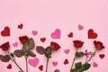 True love. Red roses with decorative paper hearts on pink background Royalty Free Stock Photo