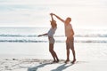 True love stories never have endings. a young couple dancing together at the beach. Royalty Free Stock Photo