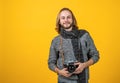 A true shutterbug. Photographer yellow background. Photographer hold photo camera.