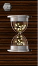 True transparent hourglass with glowing lights inside, isolated on wooden background. Simple and elegant hourglass timer