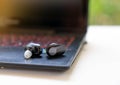 True Wireless Earbuds Basic on laptop relax in front house Royalty Free Stock Photo