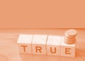 True word on wooden cubes on red. True or false facts, real and fake news concept Royalty Free Stock Photo