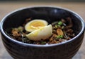 Truffle beef donburi Japanese rice topped with yakiniku beef, garlic chips, egg and truffle oil serve in the table Royalty Free Stock Photo