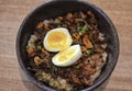 Truffle beef donburi Japanese rice topped with yakiniku beef, garlic chips, egg and truffle oil serve in the table Royalty Free Stock Photo