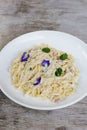 Truffled Mushroom, Bacon, Egg Fettucine pasta noodles served in a dish isolated on grey background side view