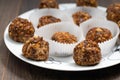 Truffles - classic no bake Chocolate coconut balls with nuts on plate