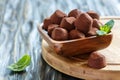 Homemade dark chocolate truffles in a wooden bowl. Royalty Free Stock Photo