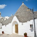 Trulli of Alberobello, Puglia, Italy: Typical houses built with dry stone walls and conical roofs. In a beautiful sunny day. Royalty Free Stock Photo