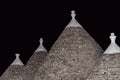 Trulli roofs in the night. Three trulli at cisternino, horizontal scenic view