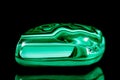 Trumbled green malachite mineral stone in front of black background