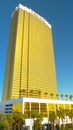 CLOSE UP: Massive gilded Trump hotel in Vegas towers above the lush palm trees.