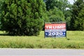 Trump 2020 life sized banner in rural overgrown field