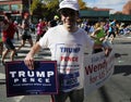 Trump supporter with political signs runs at New York City Marathon.